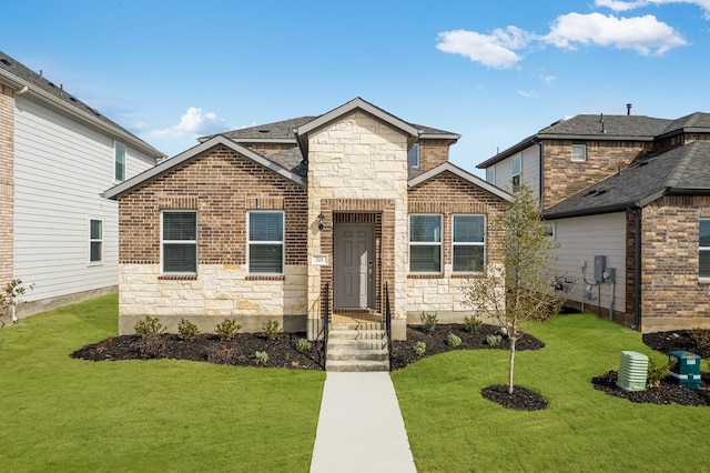 view of front facade featuring stone siding, a front lawn, and brick siding