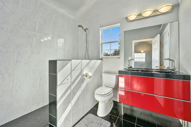 bathroom featuring tiled shower, vanity, vaulted ceiling, and a textured ceiling