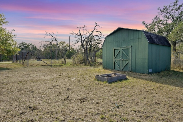 outdoor structure at dusk with a lawn