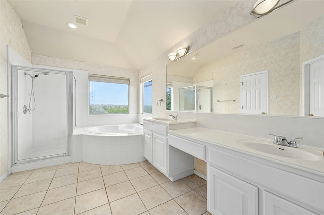 bathroom featuring independent shower and bath, vanity, lofted ceiling, and tile patterned flooring