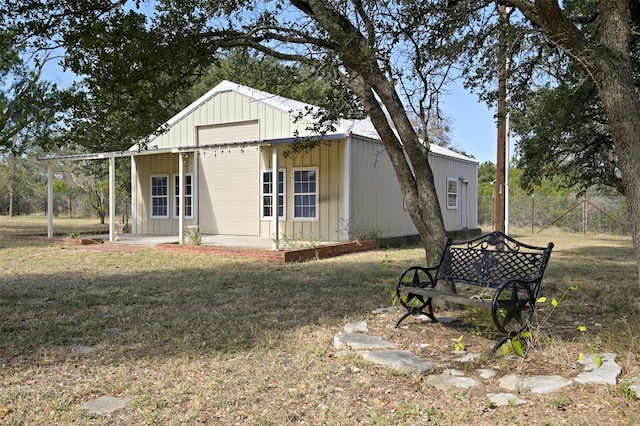 exterior space with an outdoor structure and a front lawn