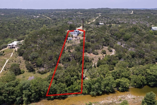 birds eye view of property with a forest view