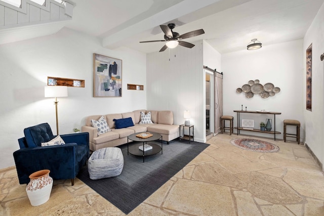 living area featuring a barn door, stone tile floors, lofted ceiling with beams, and ceiling fan