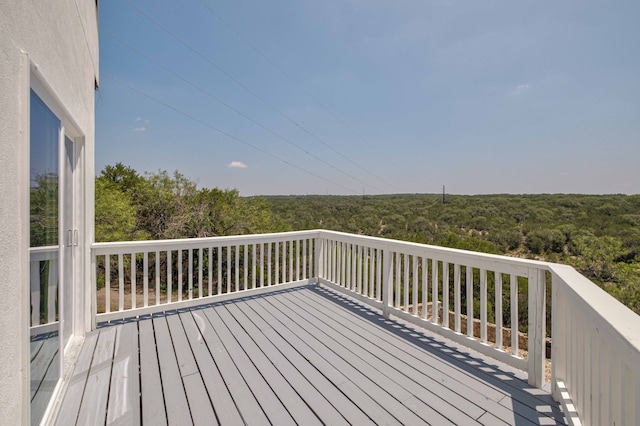 wooden deck featuring a wooded view