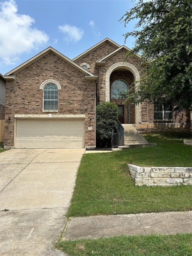 view of front of home featuring a garage and a front lawn