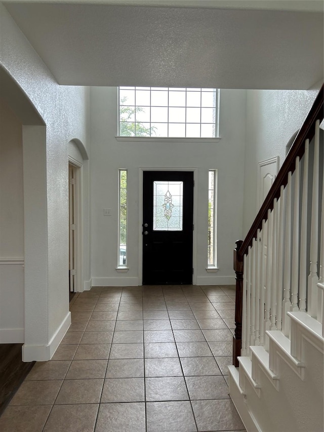 tiled foyer entrance featuring a high ceiling