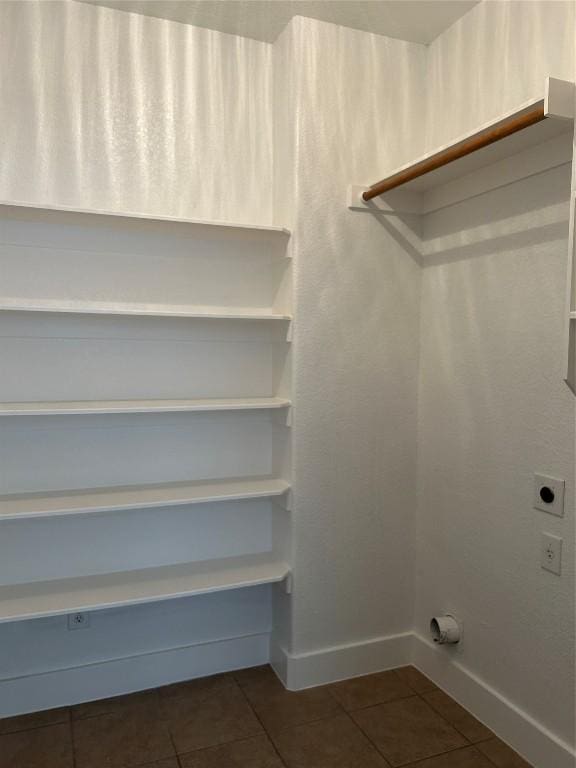 walk in closet featuring dark tile patterned flooring