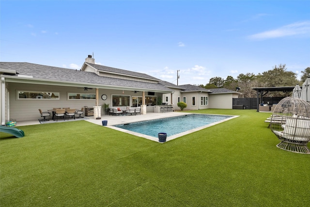 view of swimming pool with ceiling fan, a lawn, a pergola, a patio area, and an outdoor hangout area