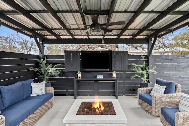 view of patio / terrace featuring ceiling fan and an outdoor fire pit