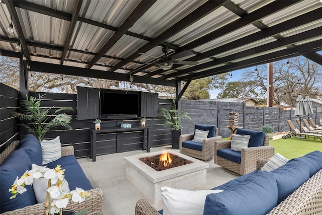 view of patio / terrace featuring ceiling fan, exterior kitchen, and an outdoor living space with a fire pit