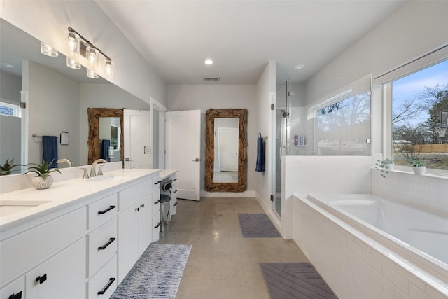 bathroom with vanity and shower with separate bathtub