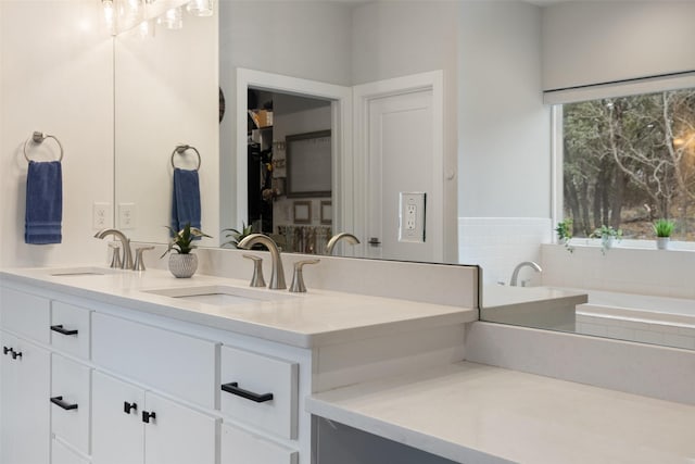 bathroom with a relaxing tiled tub and vanity