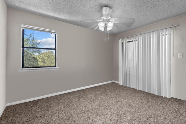 carpeted empty room with ceiling fan and a textured ceiling