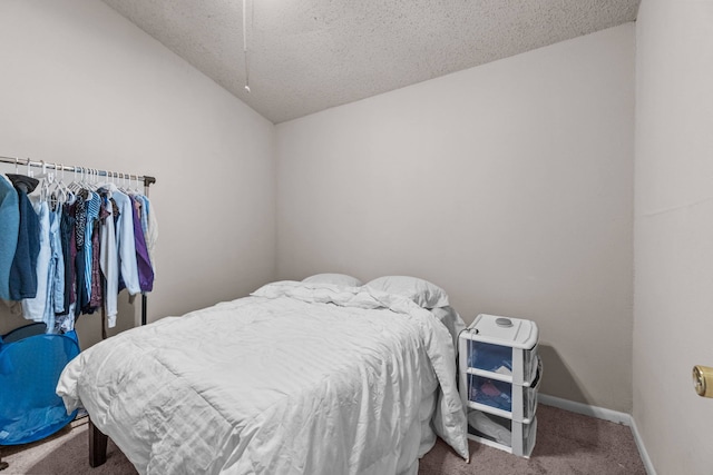 carpeted bedroom with a textured ceiling and lofted ceiling