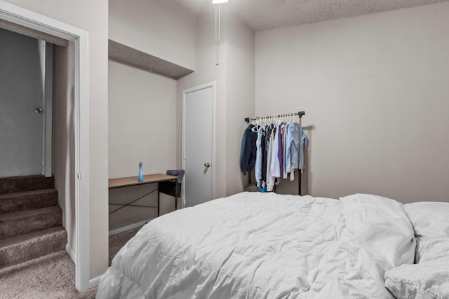 carpeted bedroom with a textured ceiling