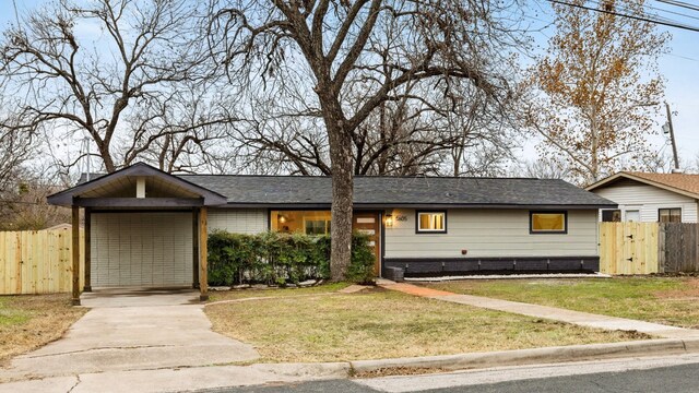 ranch-style house featuring a carport and a front yard