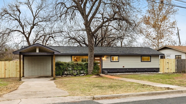 ranch-style home with a carport and a front lawn