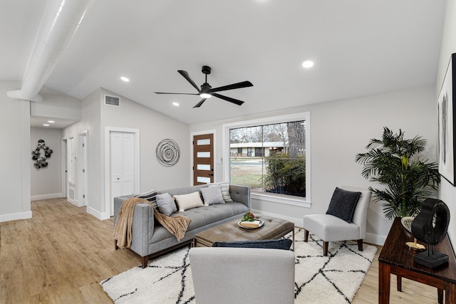 living room featuring vaulted ceiling, ceiling fan, and light hardwood / wood-style flooring