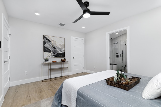 bedroom with hardwood / wood-style flooring, ensuite bathroom, and ceiling fan