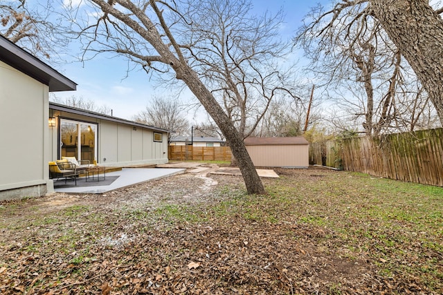 view of yard featuring a patio area and a storage unit