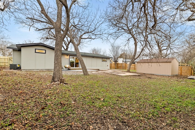 view of yard with a storage shed, central AC unit, and a patio area