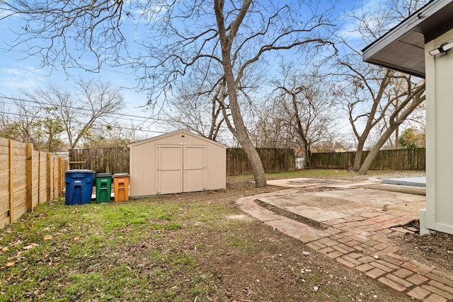 view of yard with a storage unit and a patio area