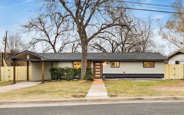 ranch-style home featuring a carport and a front yard