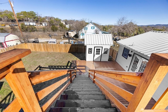 wooden terrace featuring a yard