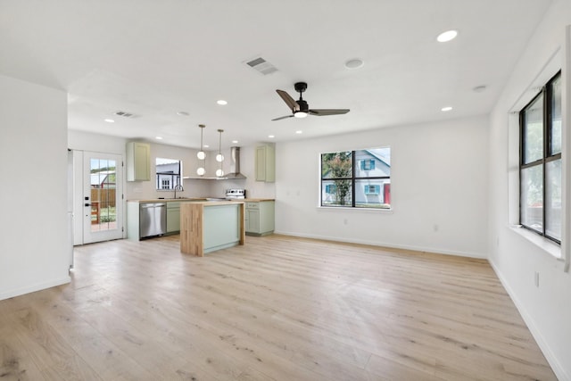 kitchen with a kitchen island, light hardwood / wood-style floors, dishwasher, and hanging light fixtures