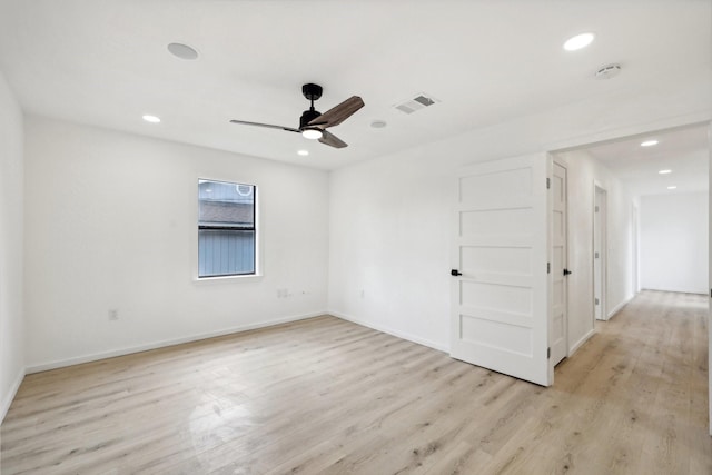 spare room with light hardwood / wood-style floors and ceiling fan