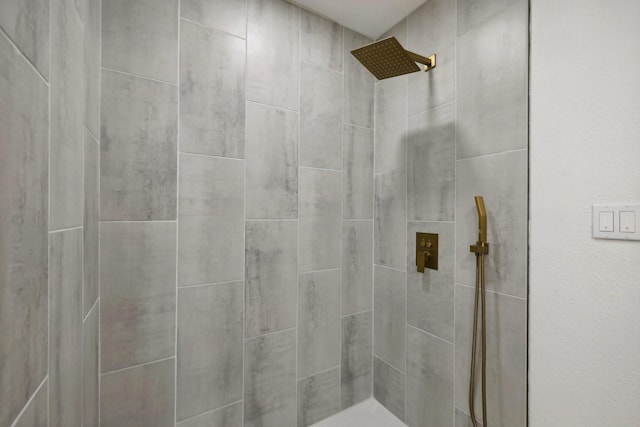 bathroom with a tile shower