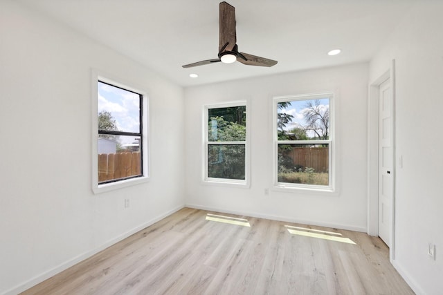 spare room featuring light hardwood / wood-style flooring and ceiling fan