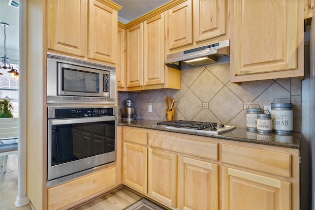 kitchen featuring tasteful backsplash, light wood-type flooring, dark stone counters, light brown cabinets, and stainless steel appliances