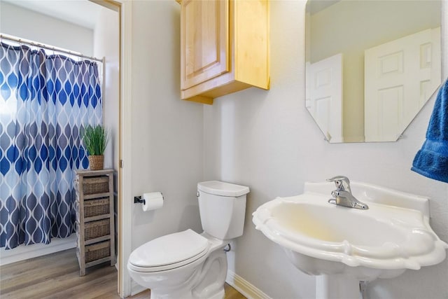 full bath featuring baseboards, a sink, toilet, and wood finished floors