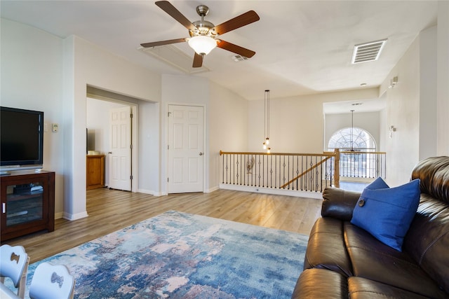 living room featuring ceiling fan and light hardwood / wood-style floors