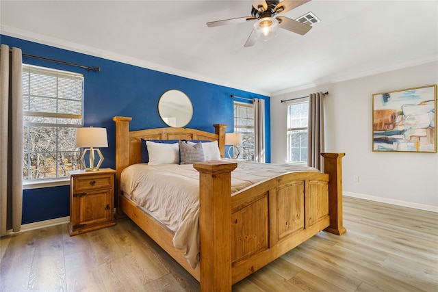 bedroom with crown molding, ceiling fan, and light wood-type flooring