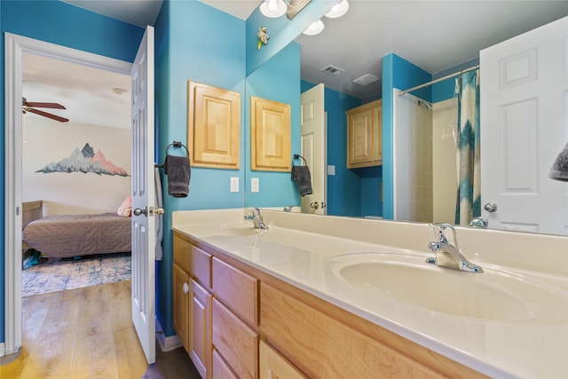 bathroom featuring a shower with curtain, ceiling fan, wood-type flooring, and vanity