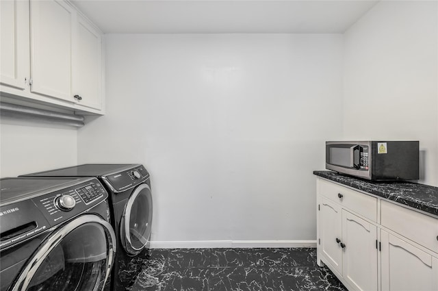 laundry area featuring cabinets and washer and clothes dryer