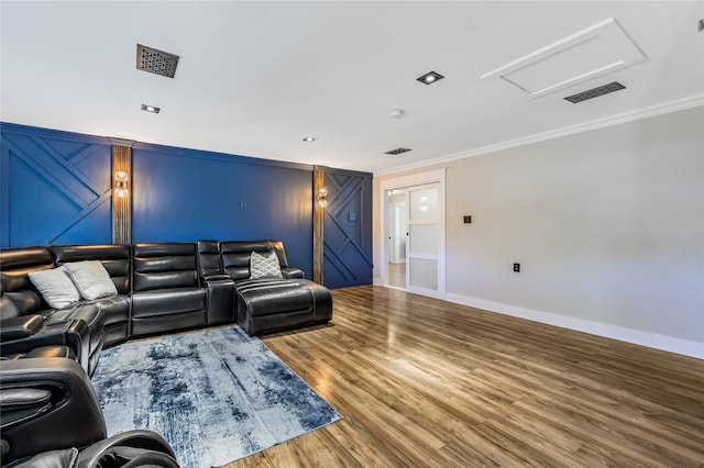 living room featuring wood-type flooring and crown molding