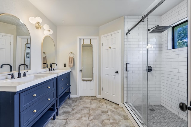 bathroom with a shower with shower door, vanity, and tile patterned flooring