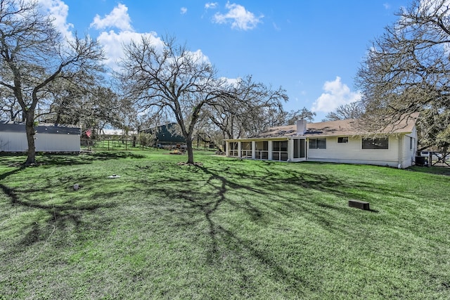 view of yard with a sunroom