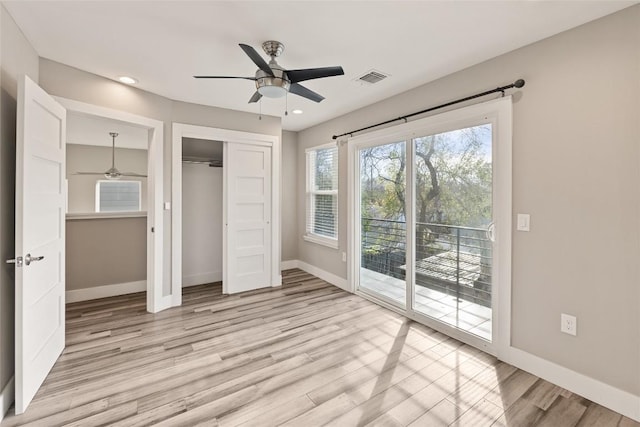 unfurnished bedroom with visible vents, baseboards, light wood-style flooring, access to outside, and a closet