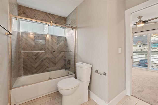 bathroom with baseboards, toilet, ceiling fan, enclosed tub / shower combo, and tile patterned floors