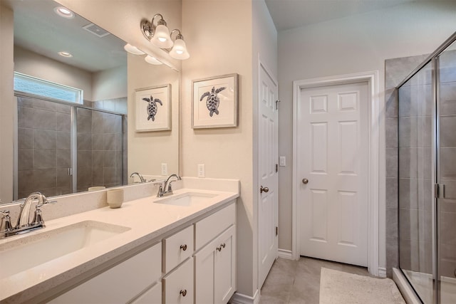 bathroom with vanity, walk in shower, and tile patterned floors