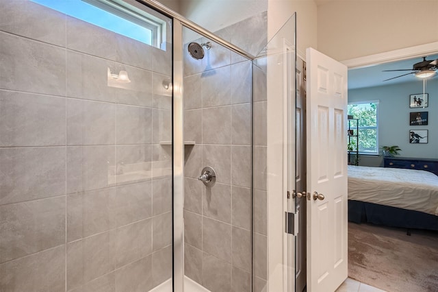 bathroom with a shower with shower door, tile patterned floors, and ceiling fan