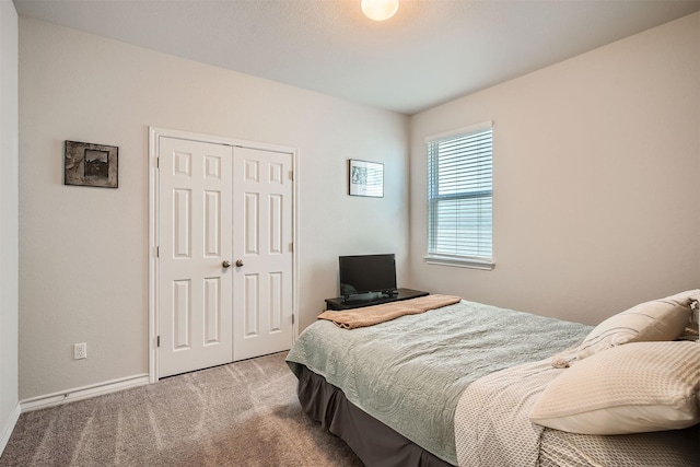 carpeted bedroom featuring a closet