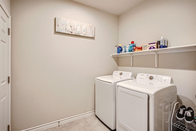 washroom featuring washing machine and dryer and light tile patterned floors