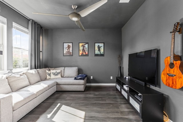 living room featuring ceiling fan and dark wood-type flooring