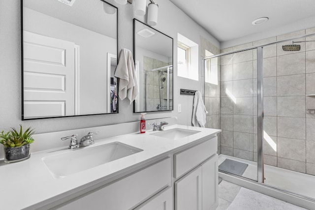 bathroom featuring an enclosed shower and vanity