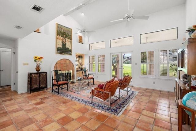 interior space with ceiling fan, french doors, a tile fireplace, and lofted ceiling